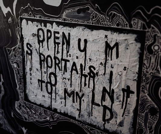 Close-up detail of abstract text artwork by The Jana Saga reading ‘Open your portals to my mind’