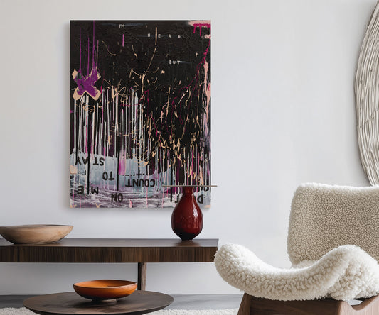 Large black abstract wall art with pink and gold details by The Jana Saga styled in a modern living room.