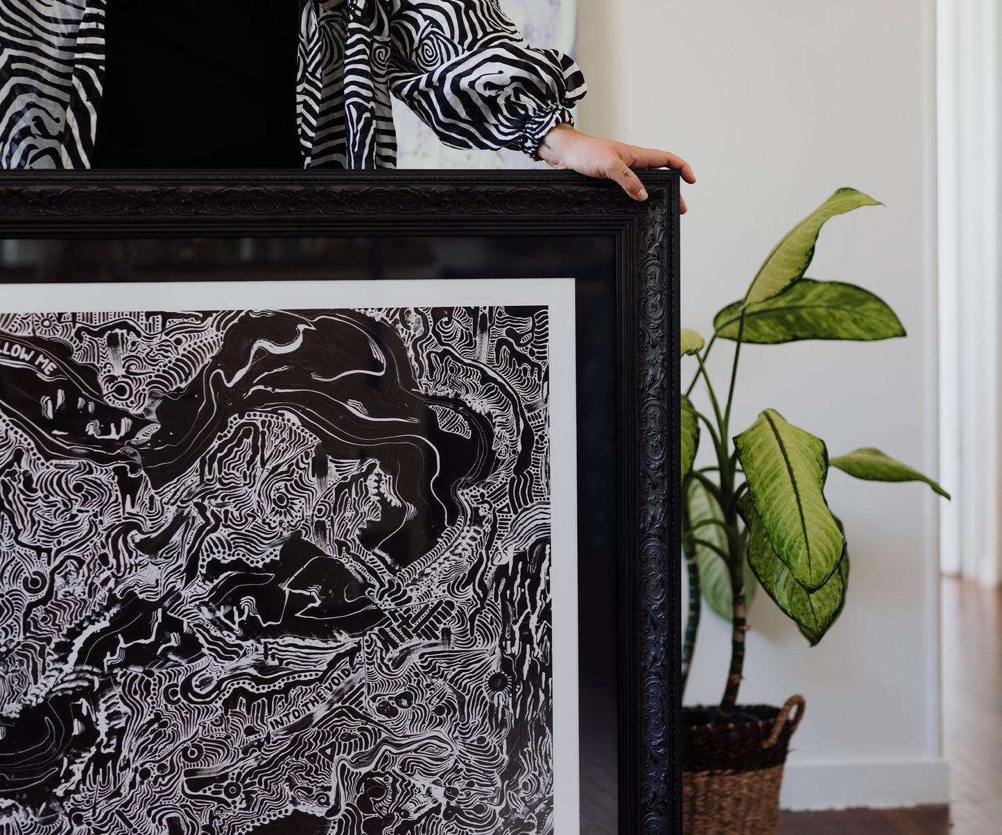 Framed black and white contemporary art print in an ornate black frame.