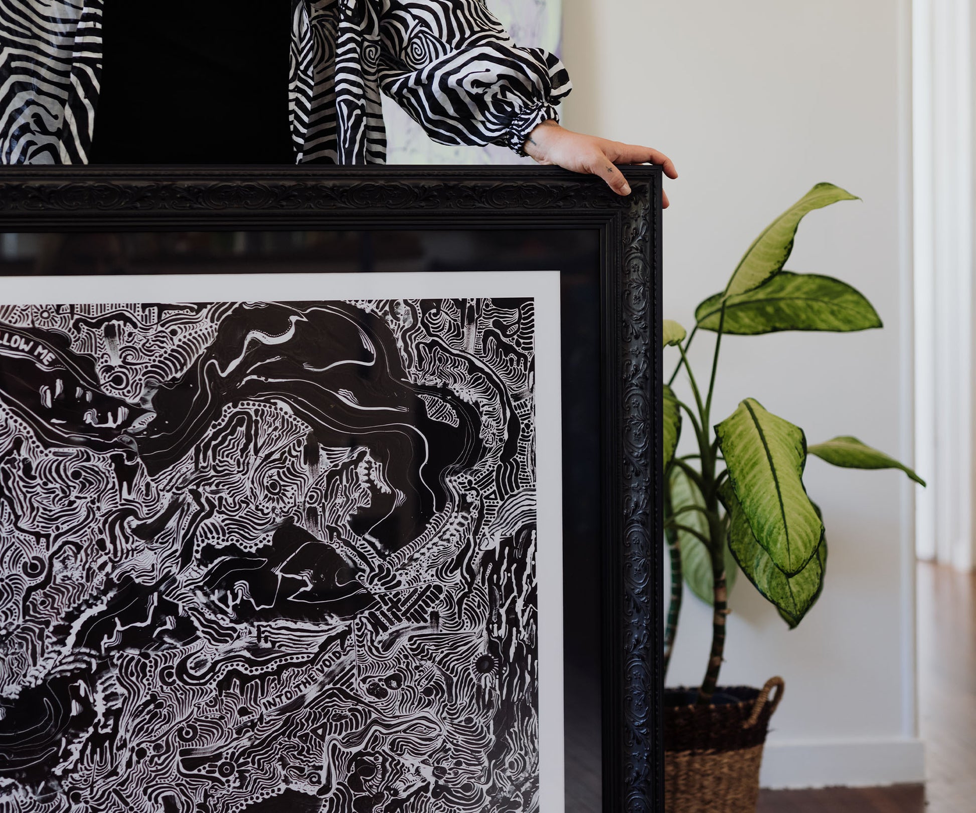 Framed black and white contemporary art print in an ornate black frame.