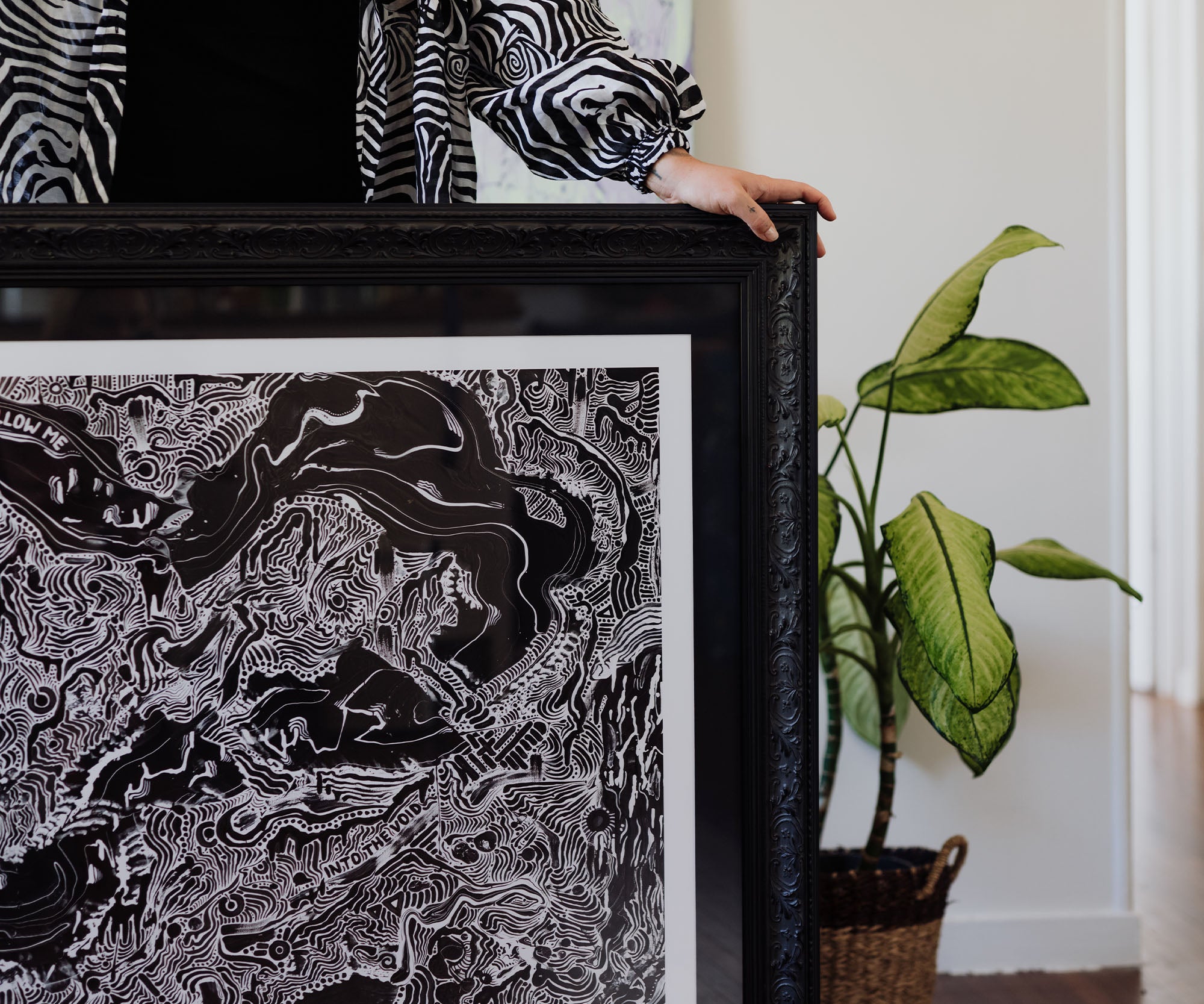 Framed black and white contemporary art print in an ornate black frame.