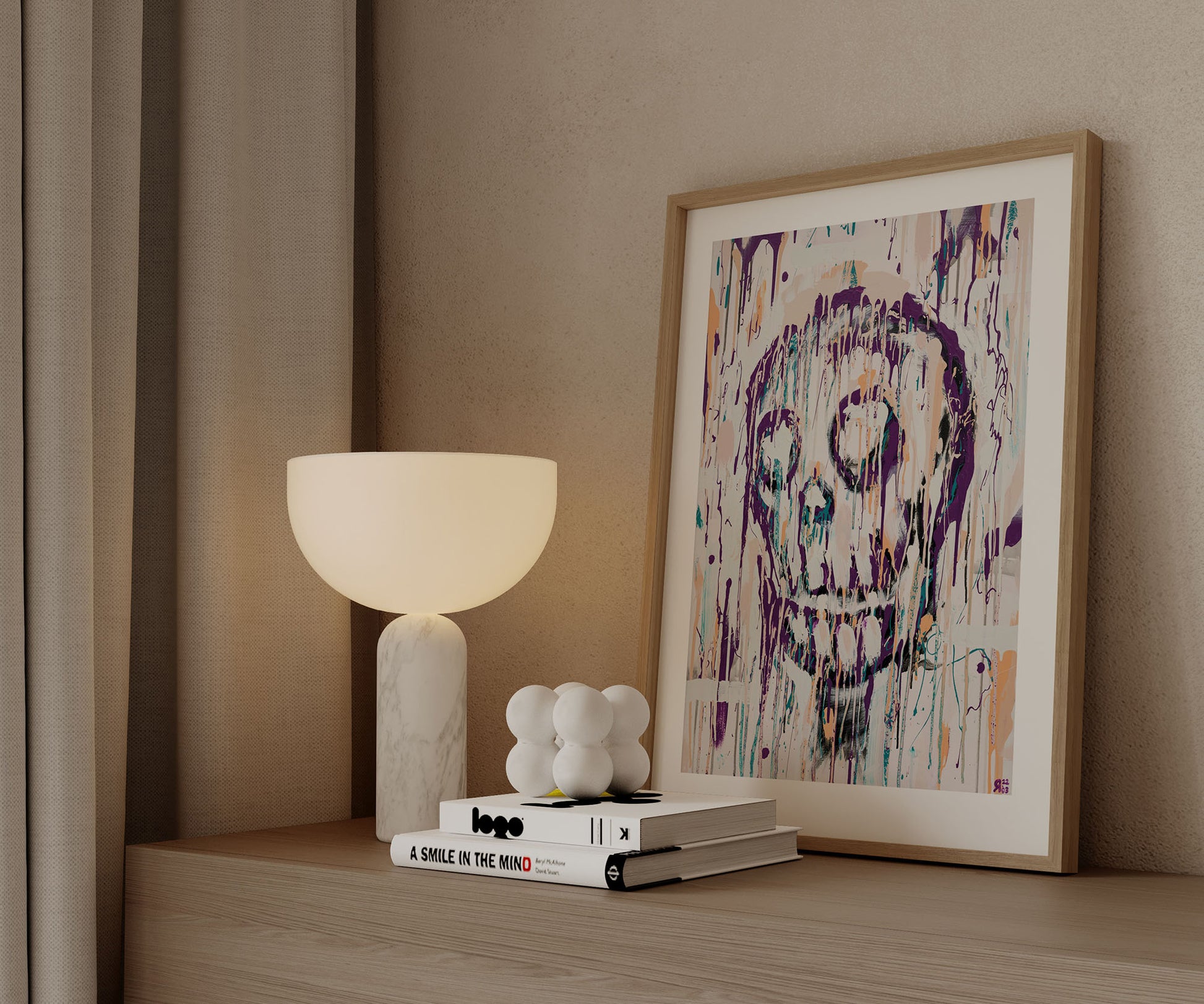 Framed abstract skull art print styled on a wooden cabinet with modern decor.