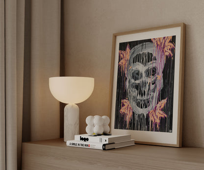 Framed skull abstract art print styled on a wooden cabinet with modern decor.