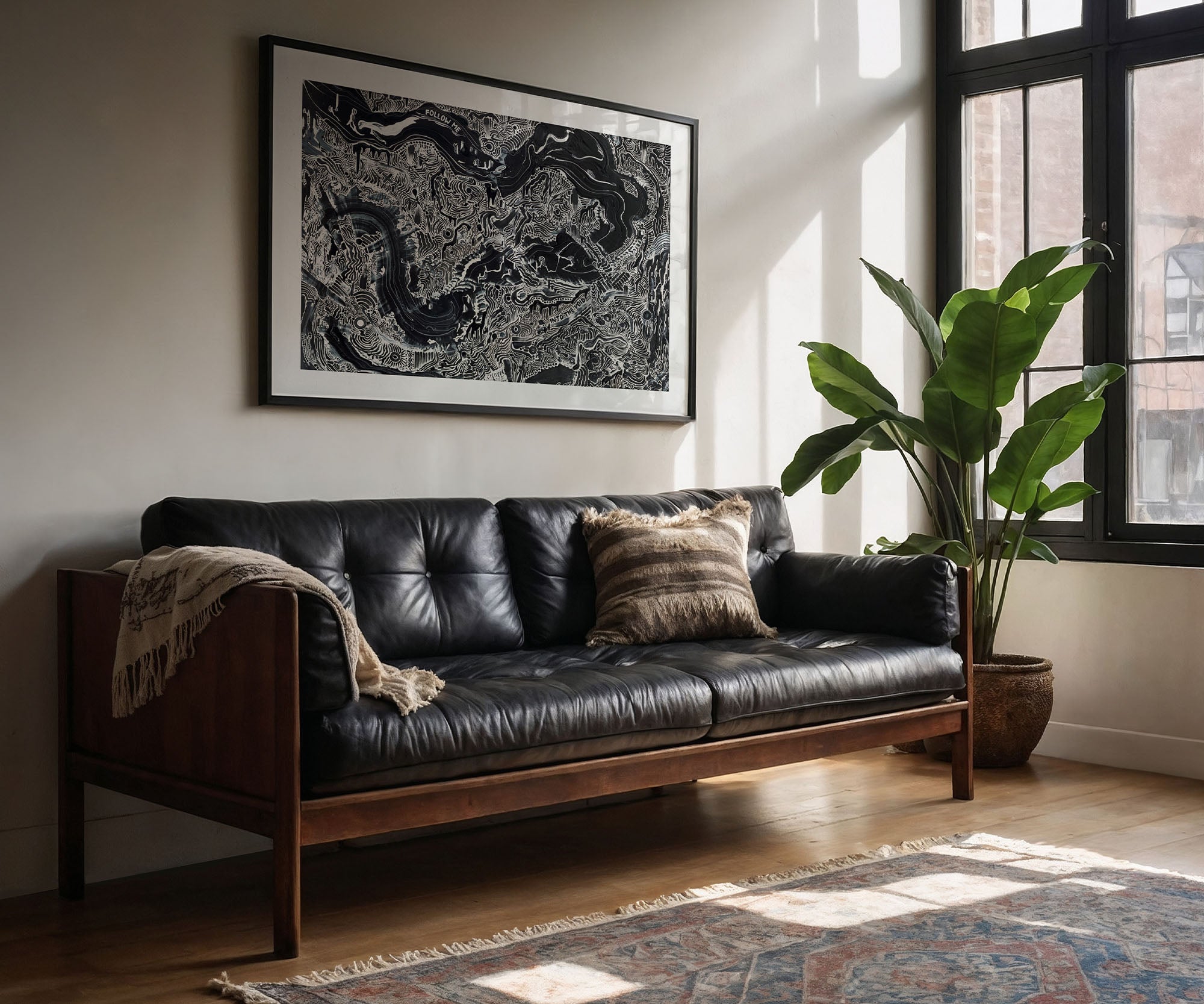 Large black and white abstract wall art print hanging above a sofa in a modern living room.