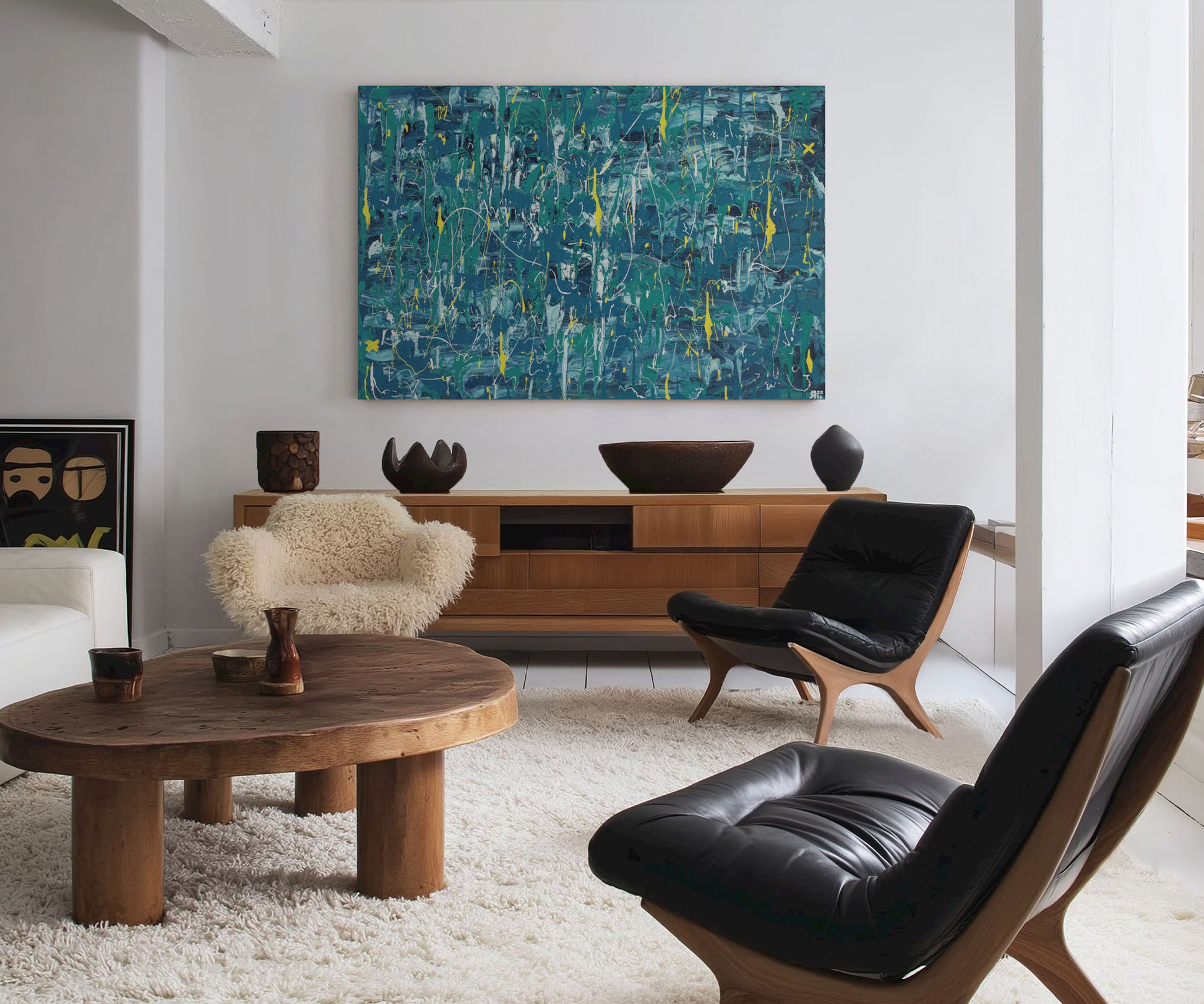Large blue abstract artwork displayed above a wooden cabinet in a modern living room.