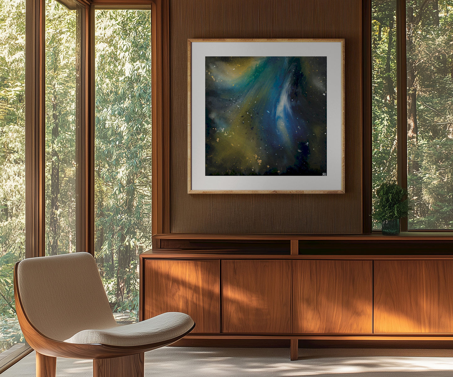 Framed abstract cosmic art print by The Jana Saga styled above a wooden cabinet in a modern interior.