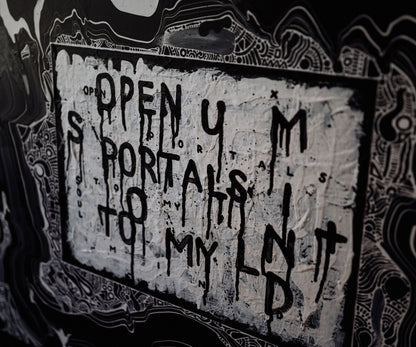 Close-up detail of abstract text artwork by The Jana Saga reading ‘Open your portals to my mind’