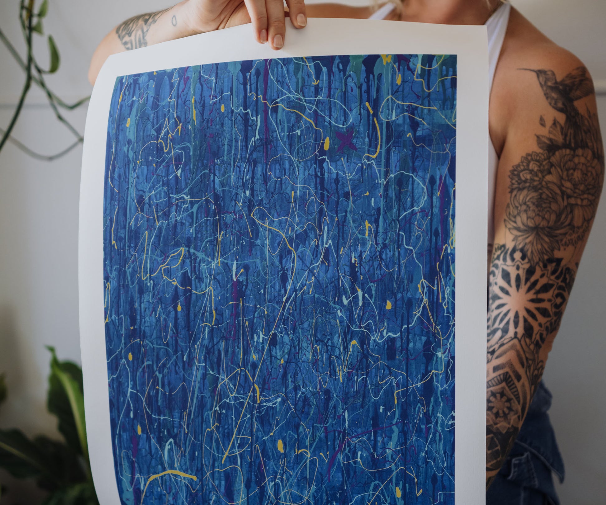 Person holding a blue abstract wall art print by The Jana Saga showing textured paint details.