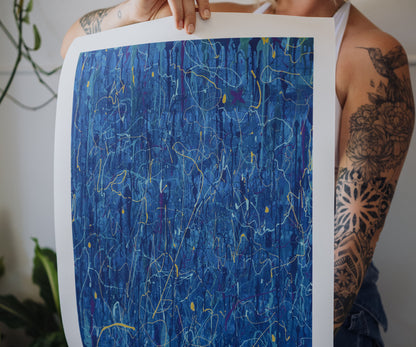 Person holding a blue abstract wall art print by The Jana Saga showing textured paint details.