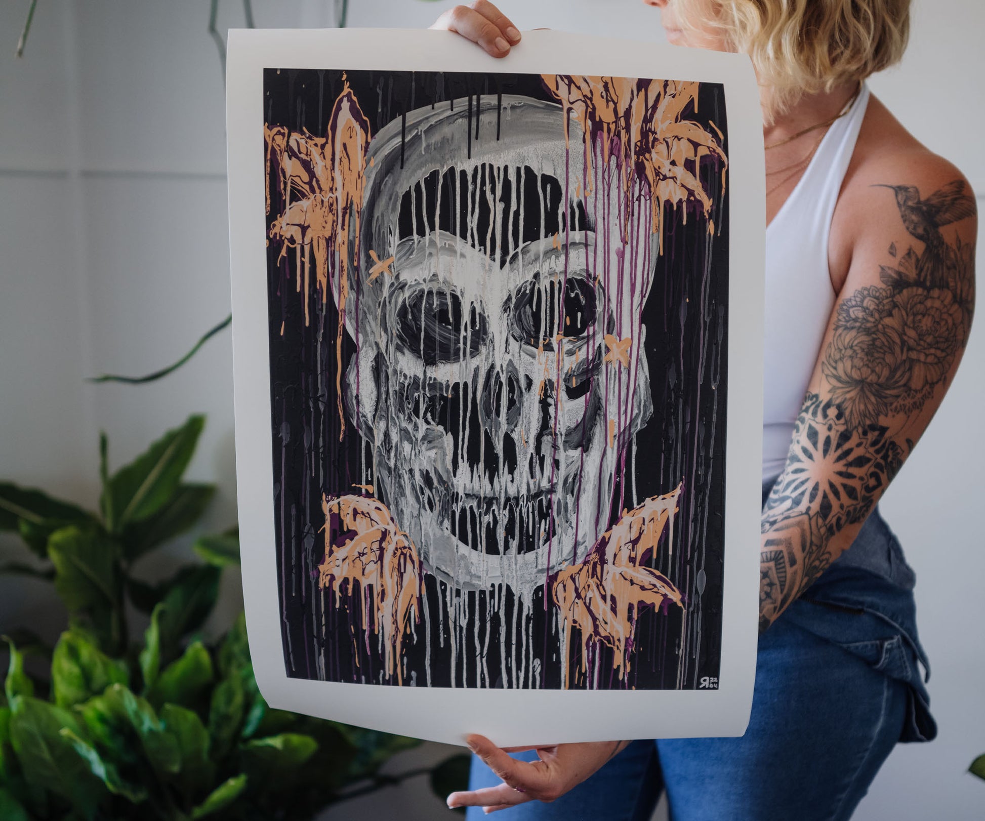 Artist holding a large skull abstract art print by The Jana Saga.